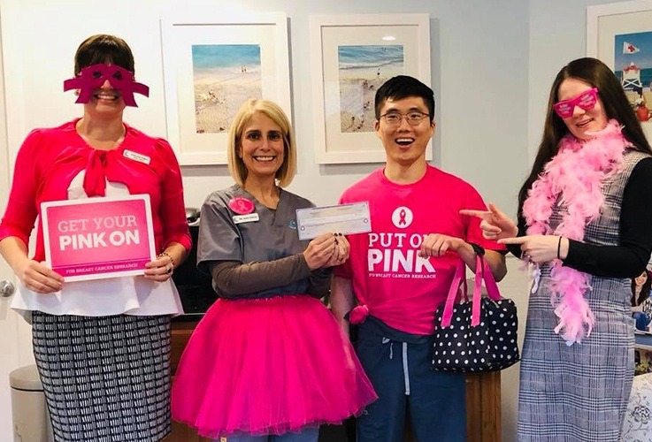 Team members celebrating breast cancer awareness month