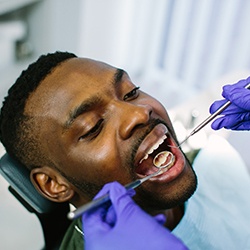 close up of a patient’s mouth being examined after getting a filling