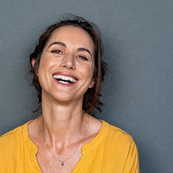 woman smiling knowing how dental implants work
