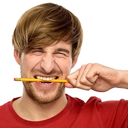 man showing a bad habit by biting a pencil