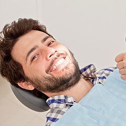 man after getting a dental checkup with his implant dentist in Westhampton