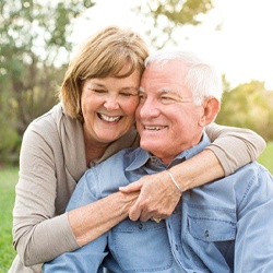 older couple smiling hugging
