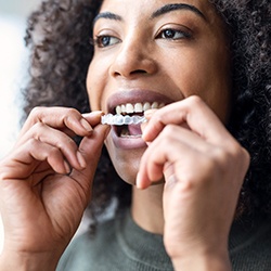 woman easily putting in her Invisalign tray