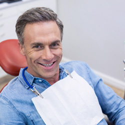 smiling middle-aged man in the dentist chair