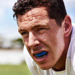 athlete breathing hard and wearing a sports mouthguard