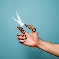 hand holding scissors