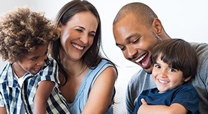 Family of four laughing together