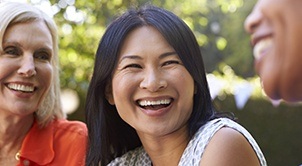 Three laughing friends outdoors