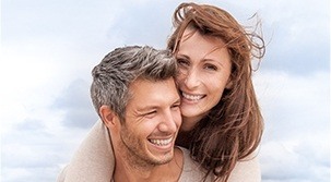 Smiling man and woman at the beach