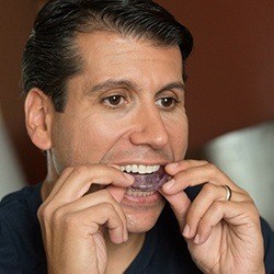 Man placing oral appliance