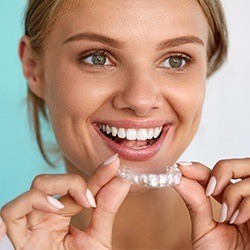 Woman placing Invisalign tray