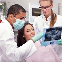 Patient and dentist looking at dental x-rays