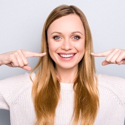 woman smiling pointing