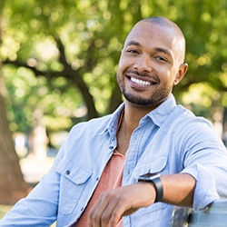 man smiling and understanding the cost of veneers in Westhampton