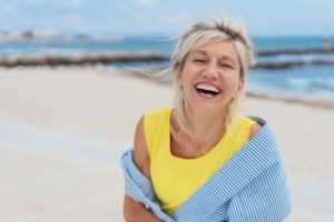 woman smiling after taking summer oral health tips