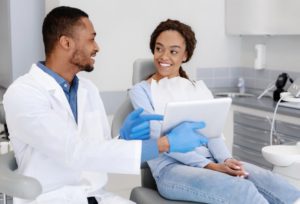 patient talking with a dentist in a dental implant consultation