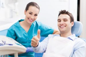 patient smiling with thumbs up