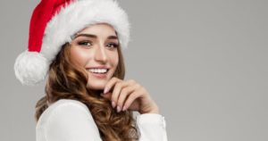woman wearing a Santa hat after getting teeth whitening