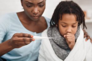 child with mother during cold and flu season