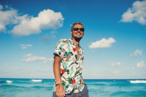 man smiling at the beach