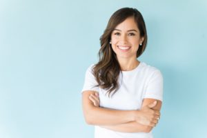 woman with an attractive smile with her arms folded