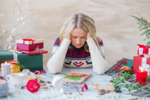 stressed woman surrounded by holiday decor